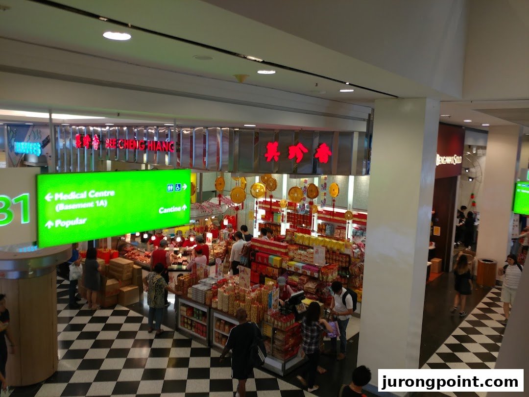 An overhead view of Bee Cheng Hiang shop, showcasing its products and customers in a bustling mall.