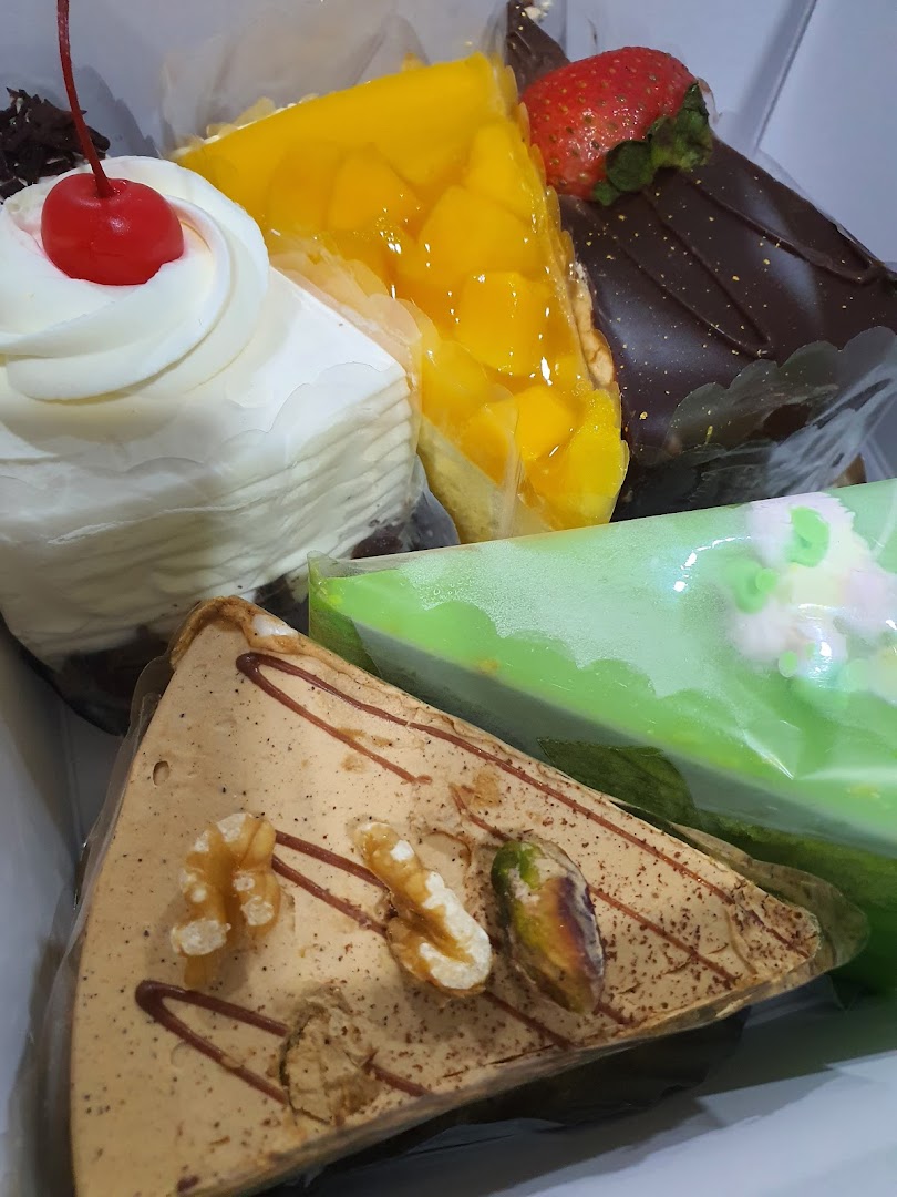 A vibrant assortment of delicious cake slices, featuring various flavors and toppings.