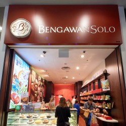 The shopfront of Bengawan Solo, a bakery and cake shop, with customers inside.