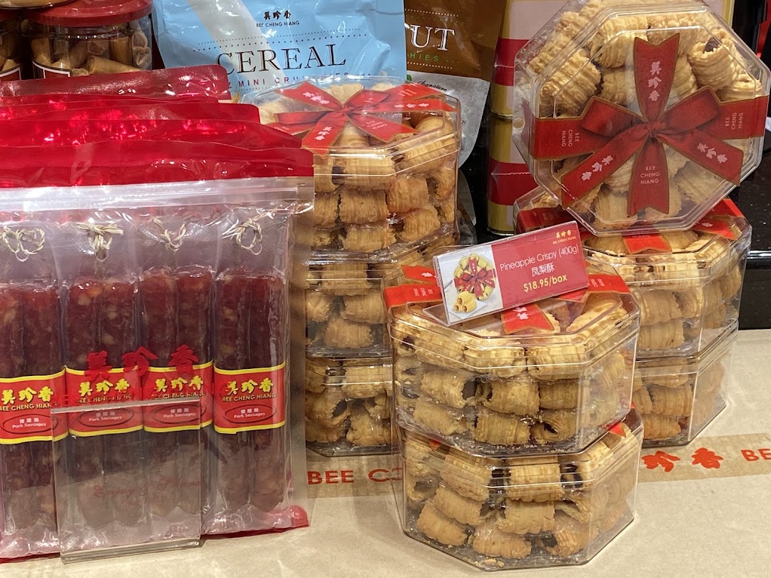 Close-up of Bee Cheng Hiang's pineapple crispy tarts and pork sausages on display.
