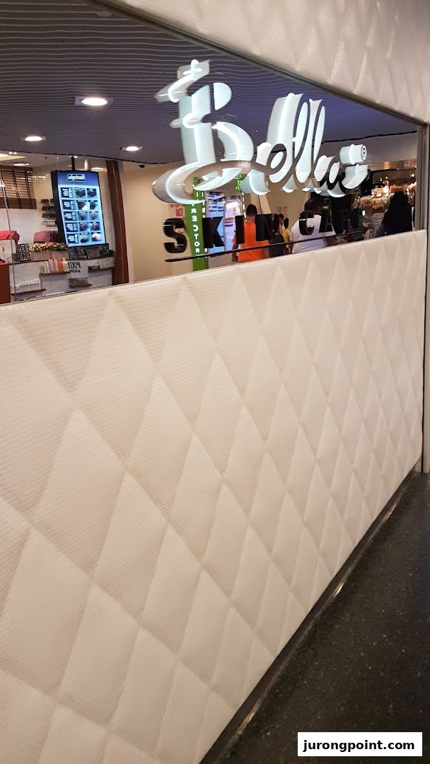 View of BMF - The Aesthetics People shop entrance with a distinctive quilted white barrier.