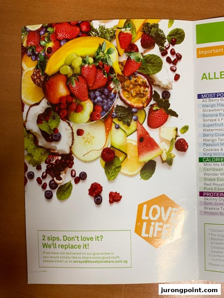 A vibrant menu page from Boost Juice featuring fresh fruits and a partial list of popular and healthy juice options.