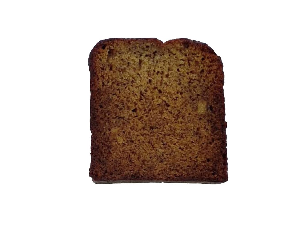 A close-up of a slice of golden-brown banana bread or similar baked good.