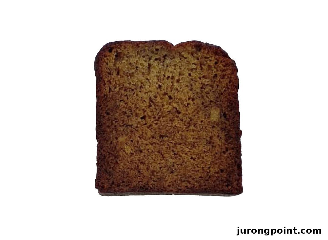 A close-up of a slice of golden-brown banana bread or similar baked good.
