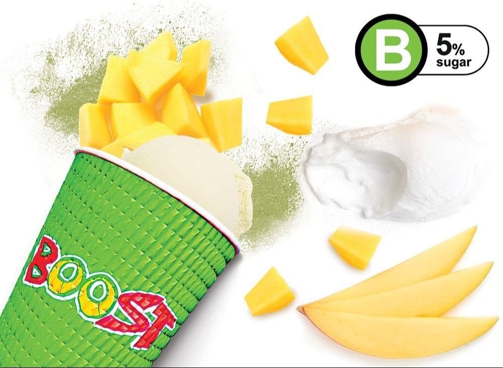 A vibrant Boost Juice cup overflowing with fresh mango pieces and creamy ingredients, highlighting a low sugar option.