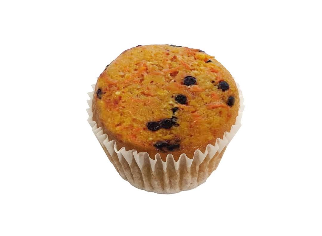 A delicious carrot muffin with chocolate chips in a white paper liner.