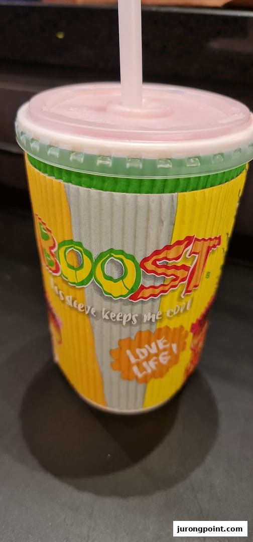 A vibrant Boost Juice cup with a straw, featuring the brand logo and 'Love Life' slogan.