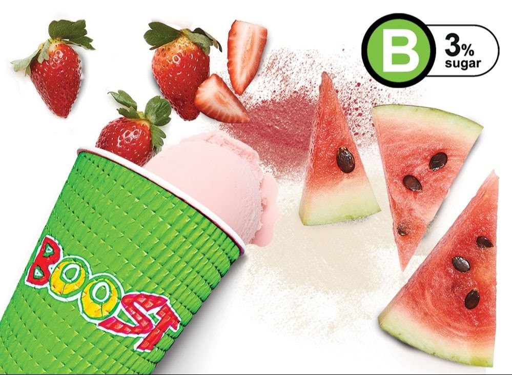 A vibrant image showcasing a Boost Juice cup with strawberries, watermelon, and a pink smoothie, highlighting fresh ingredients.