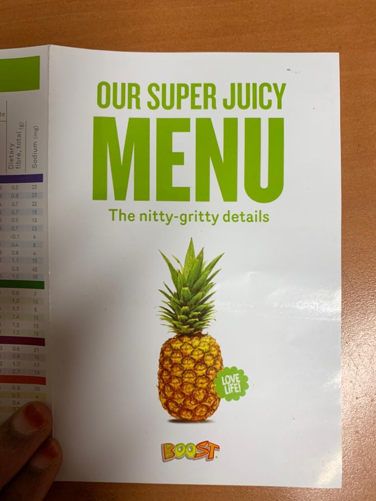 Cover of a Boost Juice menu booklet featuring a pineapple and the title 'OUR SUPER JUICY MENU'.