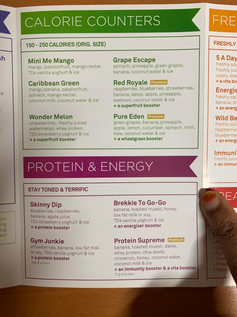 A detailed menu displaying various healthy juice and smoothie options from Boost Juice, categorized by calorie and protein content.