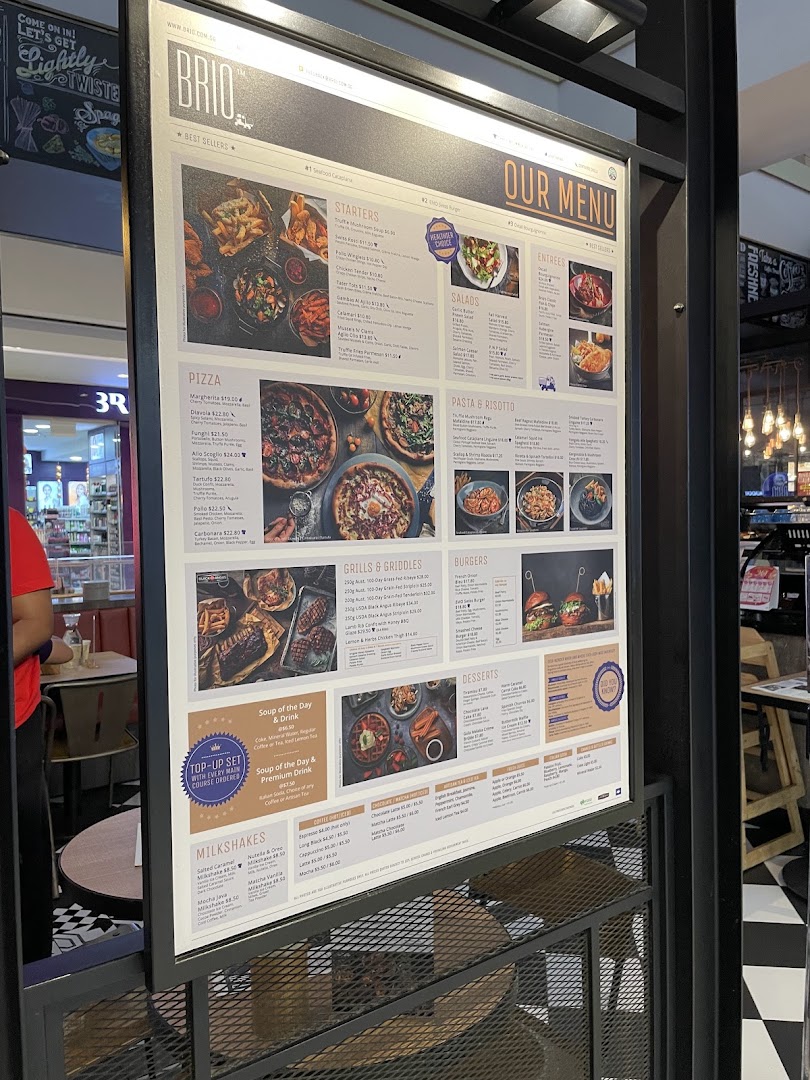 A brightly lit menu board for Brio restaurant, showcasing a wide array of dishes and drinks.