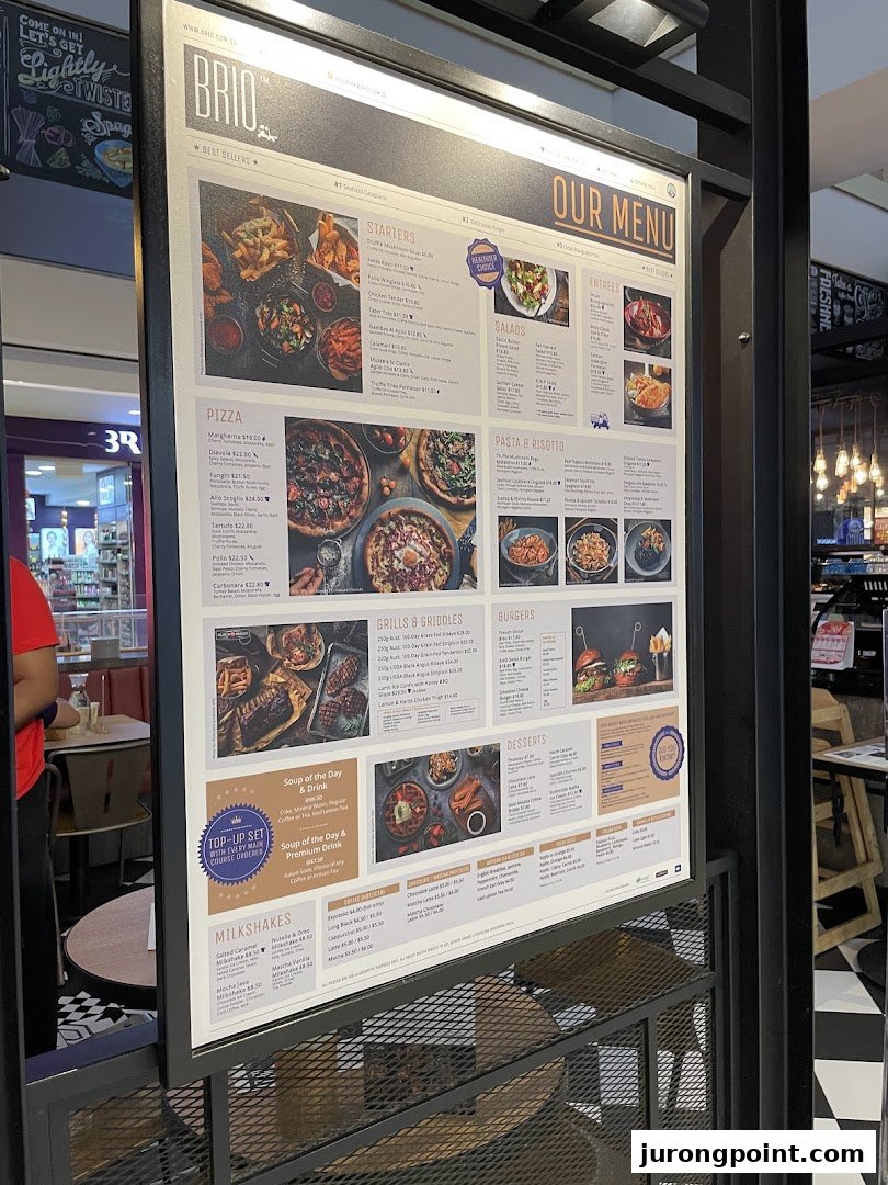 A brightly lit menu board for Brio restaurant, showcasing a wide array of dishes and drinks.