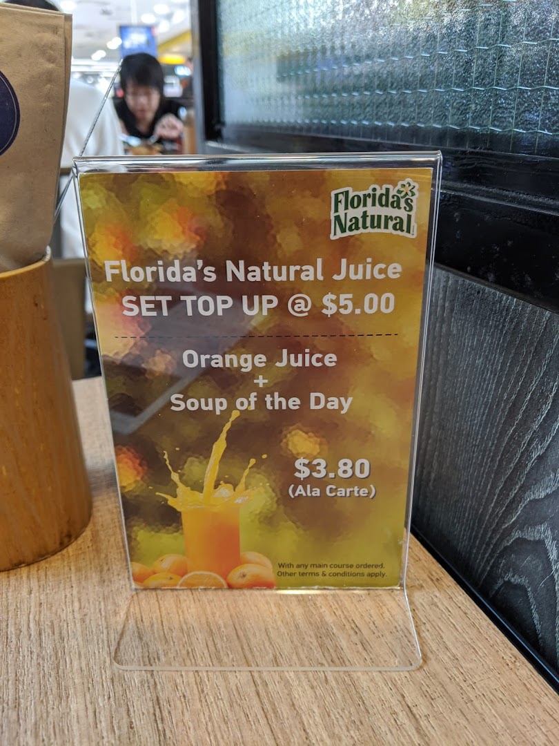 A table-top display at Brio showcasing Florida's Natural Juice offers and a soup combo.
