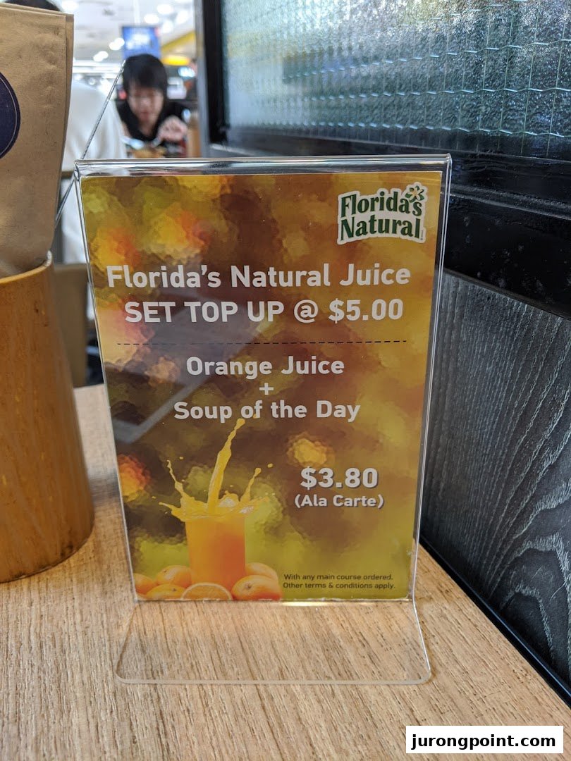 A table-top display at Brio showcasing Florida's Natural Juice offers and a soup combo.