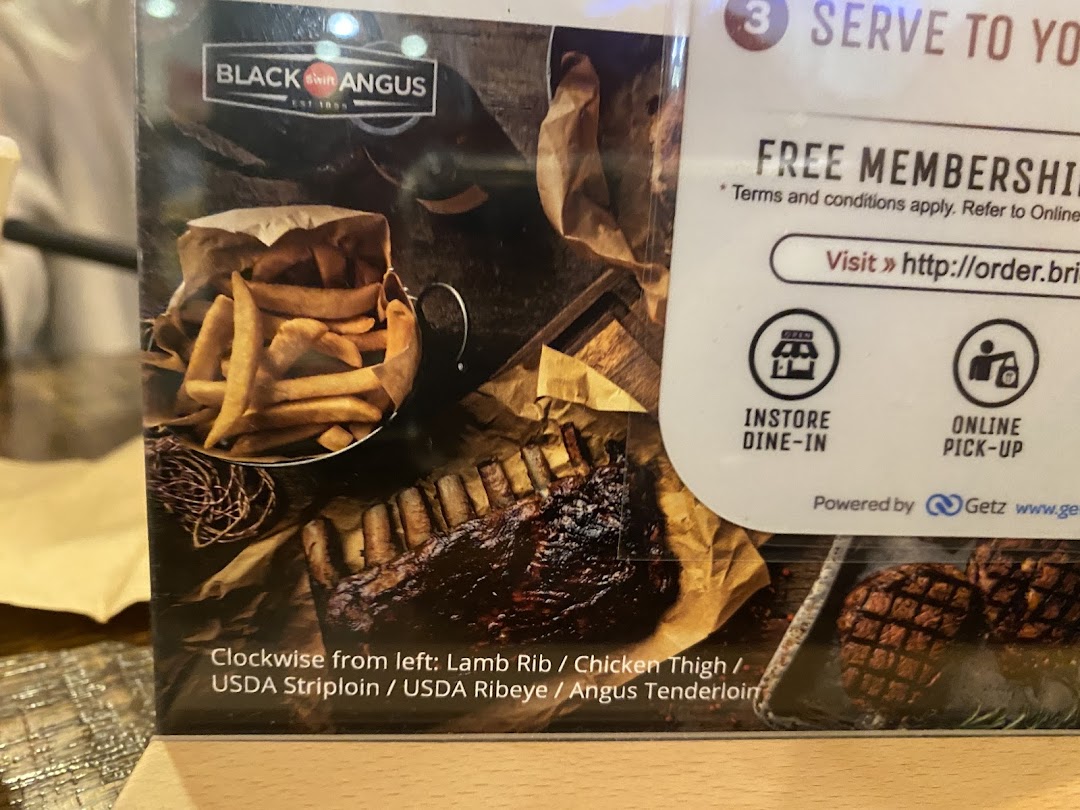 A display showcasing Black Angus ribs, fries, and information on free membership and ordering options.