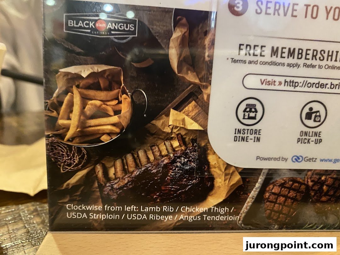 A display showcasing Black Angus ribs, fries, and information on free membership and ordering options.