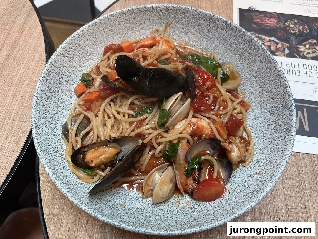 A vibrant plate of seafood spaghetti with mussels, clams, and shrimp in a rich tomato sauce.