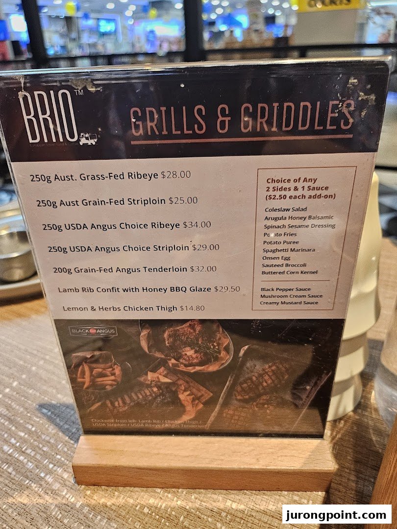 A close-up of Brio's 'Grills & Griddles' menu featuring various meat cuts, sides, and sauces.