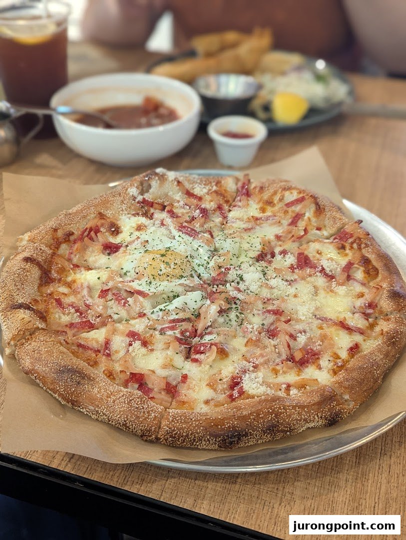 A close-up of a delicious pizza topped with cheese, bacon, and a fried egg, served at Brio.