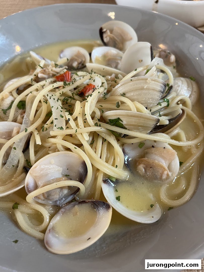 A close-up of spaghetti alle vongole, featuring clams, pasta, and a light sauce.