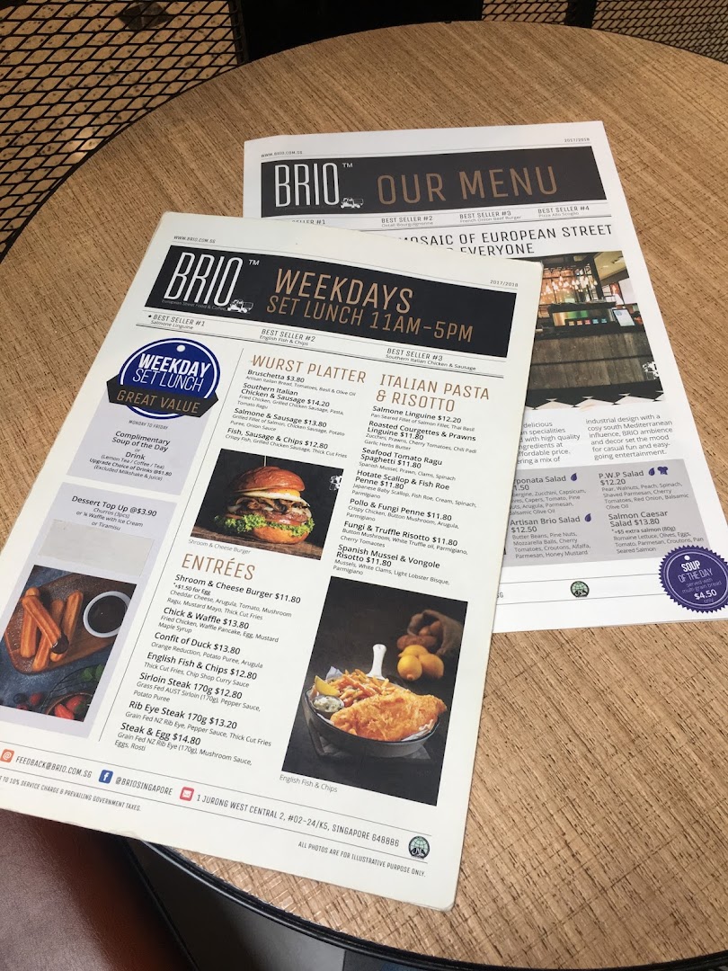 A detailed menu from Brio restaurant, showcasing various dishes and prices on a wooden table.
