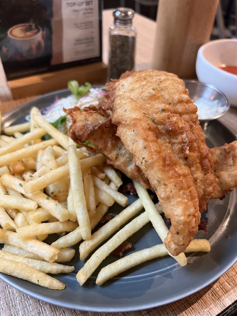 A delicious plate of golden-fried fish and chips with coleslaw and sauce at Brio.