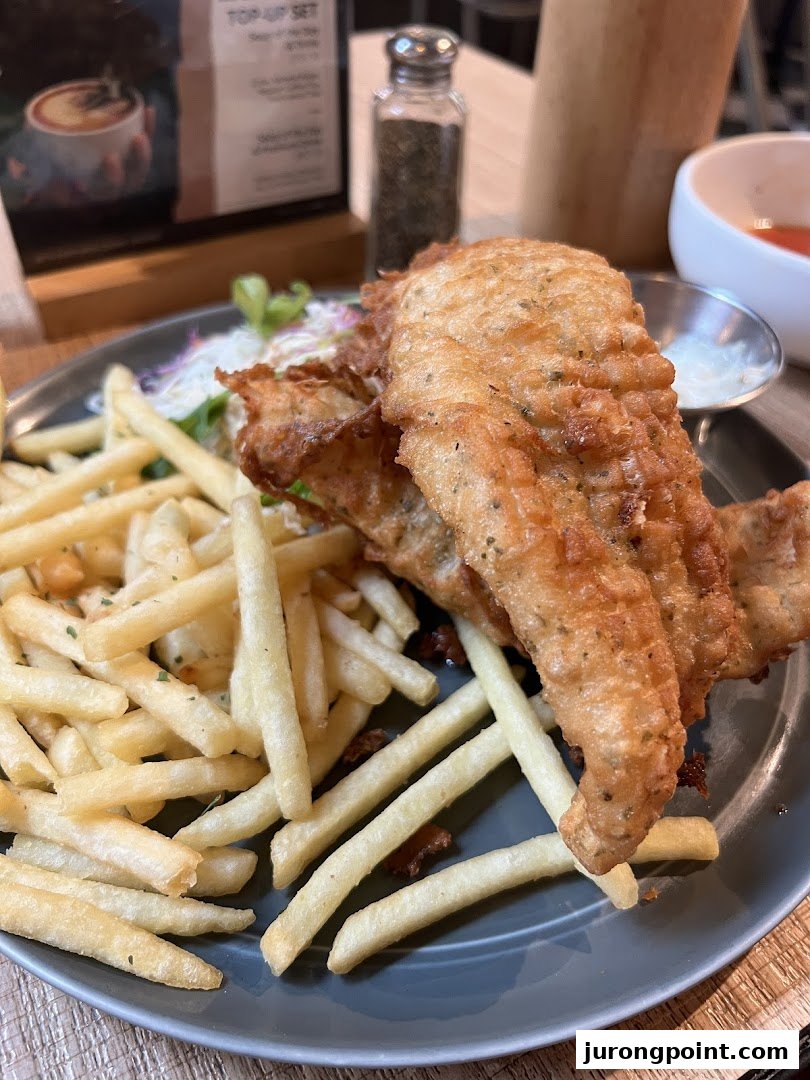 A delicious plate of golden-fried fish and chips with coleslaw and sauce at Brio.