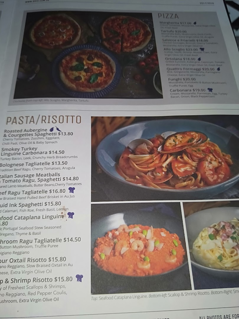 A detailed menu displaying various pizza, pasta, and risotto dishes with prices and descriptions.