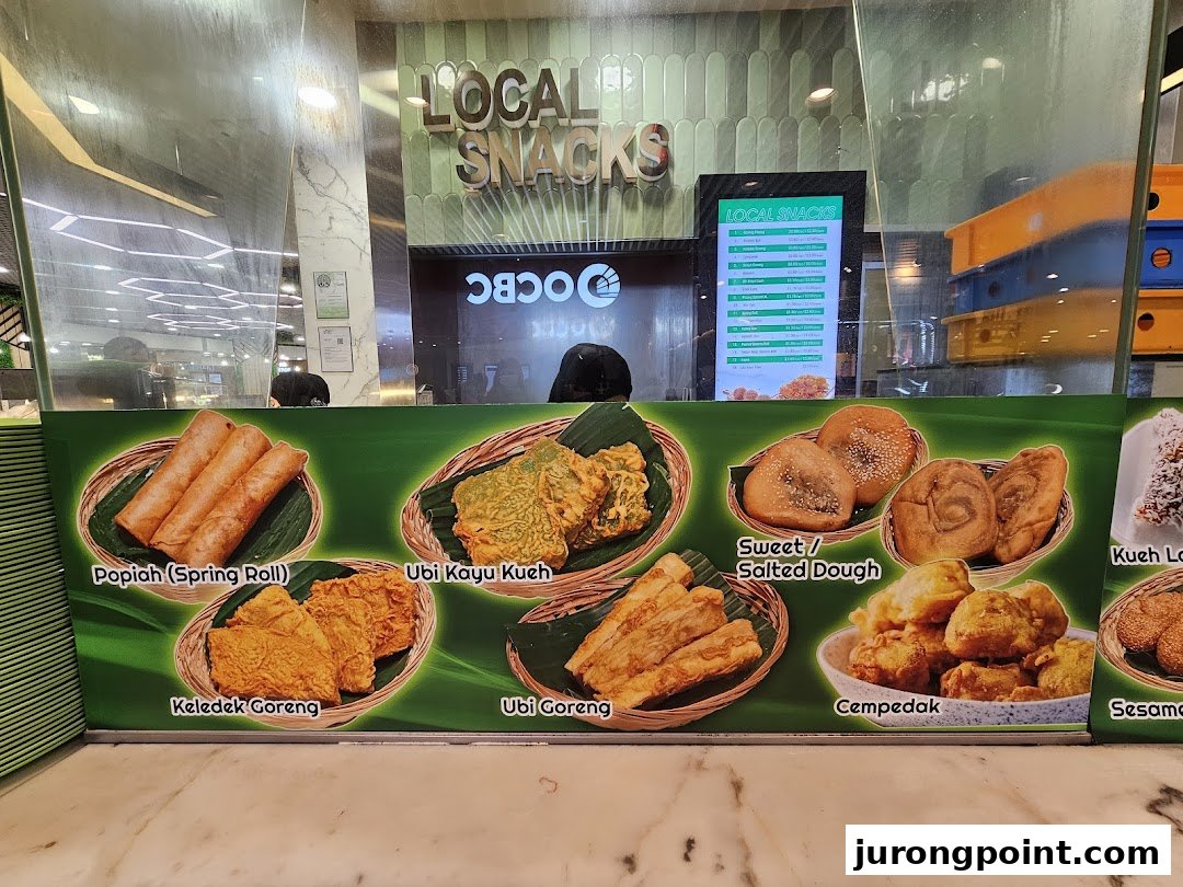 A vibrant display of traditional local snacks with a digital menu board showing prices.