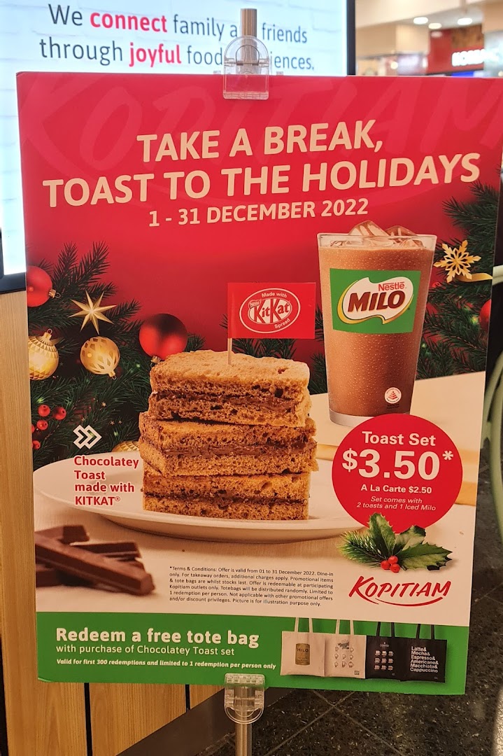 A promotional poster for Kopitiam's holiday 'Toast Set' featuring KitKat toast and Milo.