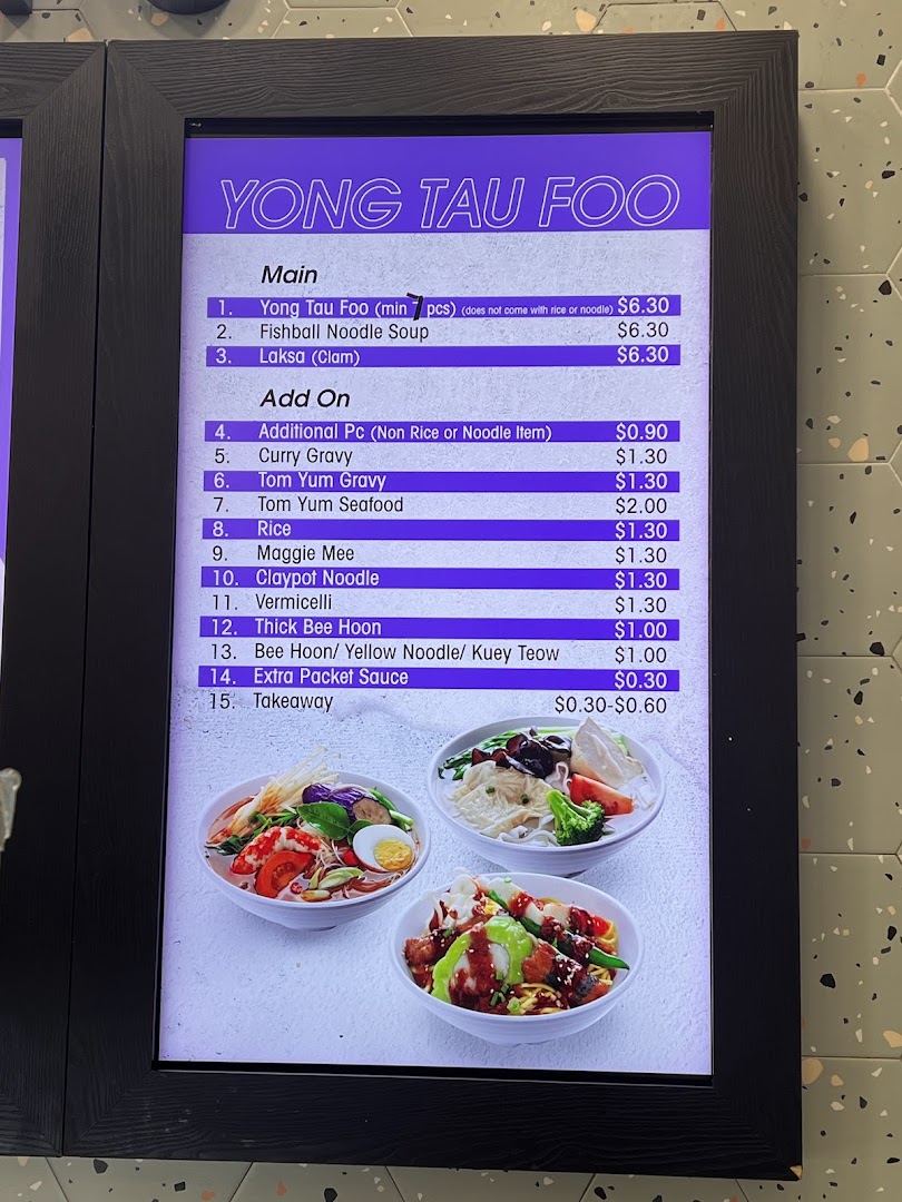 A digital menu board displaying Yong Tau Foo and add-on options with prices.