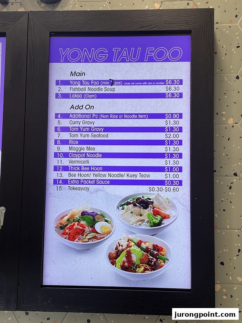 A digital menu board displaying Yong Tau Foo and add-on options with prices.