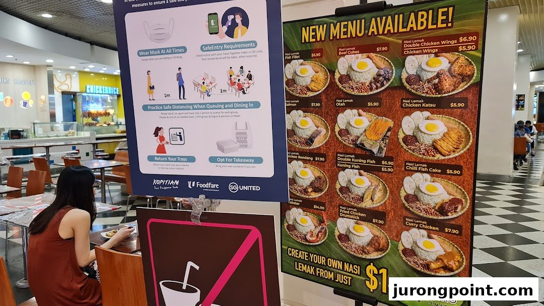 A large menu board showcasing various Nasi Lemak dishes and prices at Cantine by Kopitiam.
