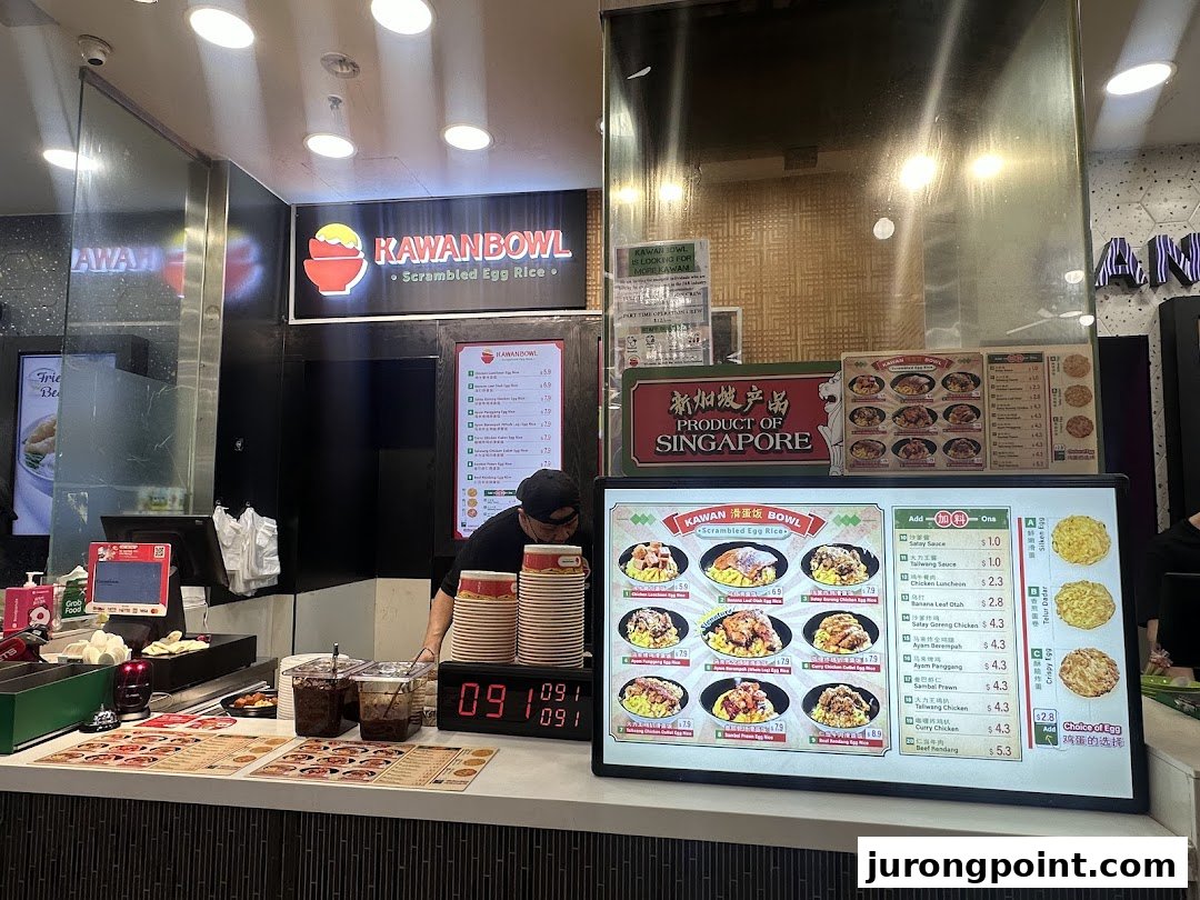 Interior view of Kawanbowl, a scrambled egg rice shop, showing the counter and menu displays.