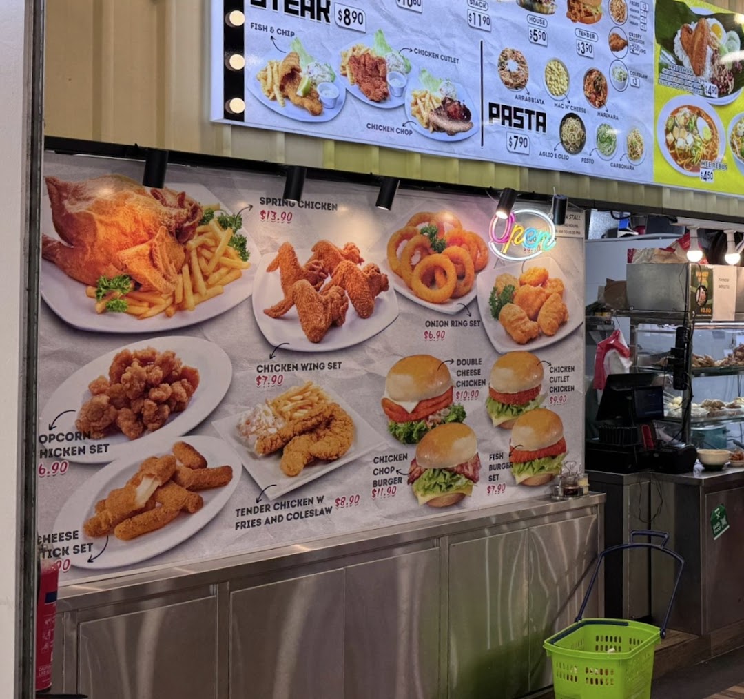A large menu board displaying a variety of fried chicken, burger, pasta, and other main dishes with prices.