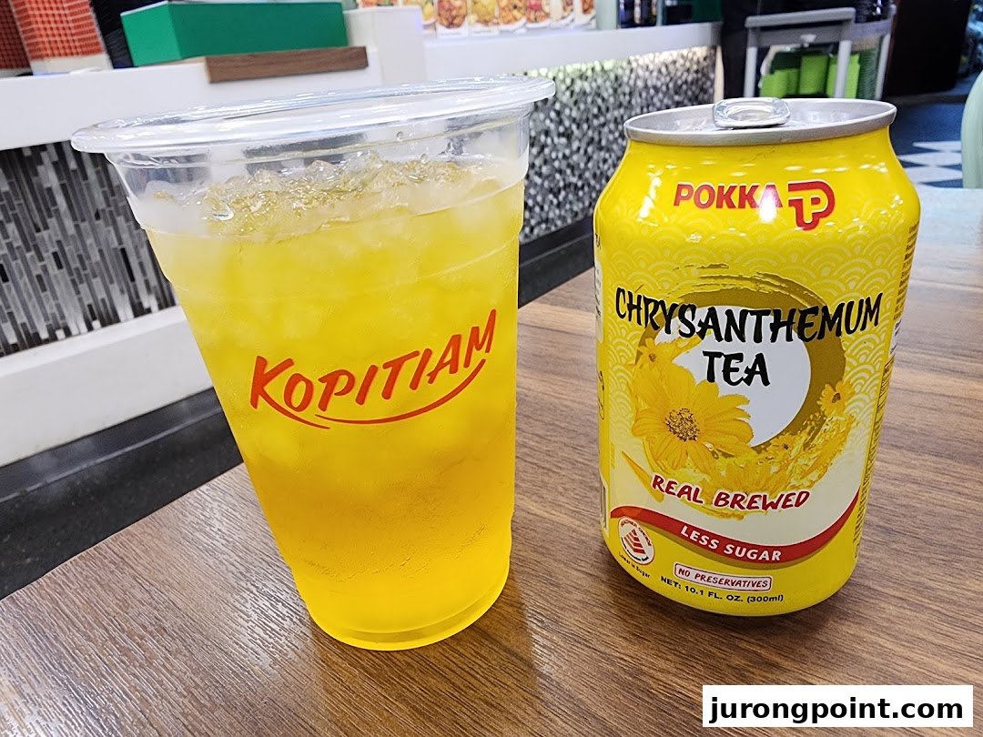 A refreshing iced drink from Kopitiam alongside a can of Pokka Chrysanthemum Tea.