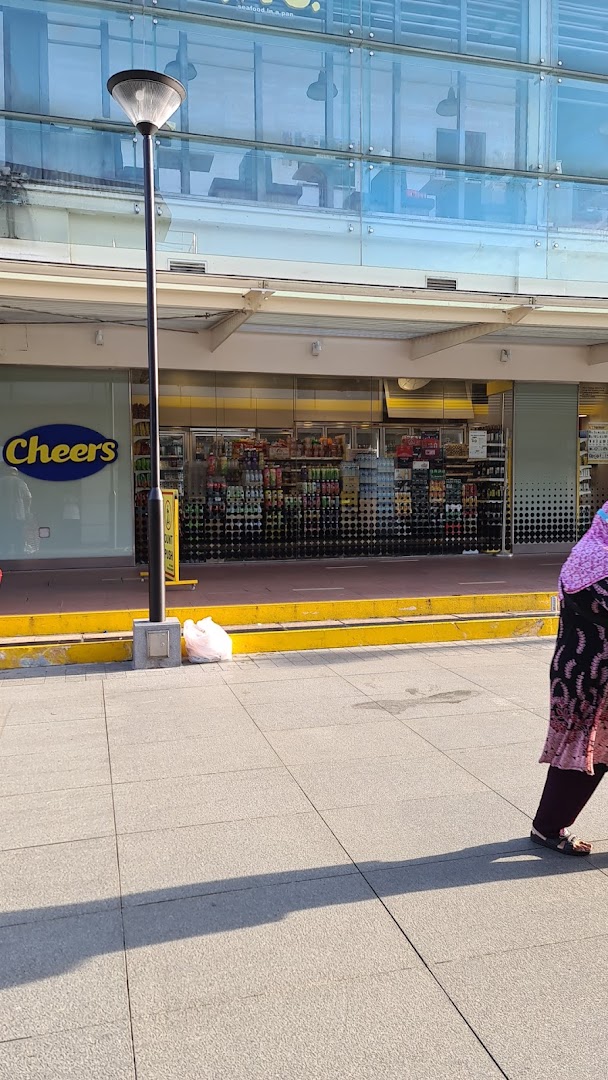 Exterior view of the Cheers convenience store, showcasing its logo and visible products through the storefront.