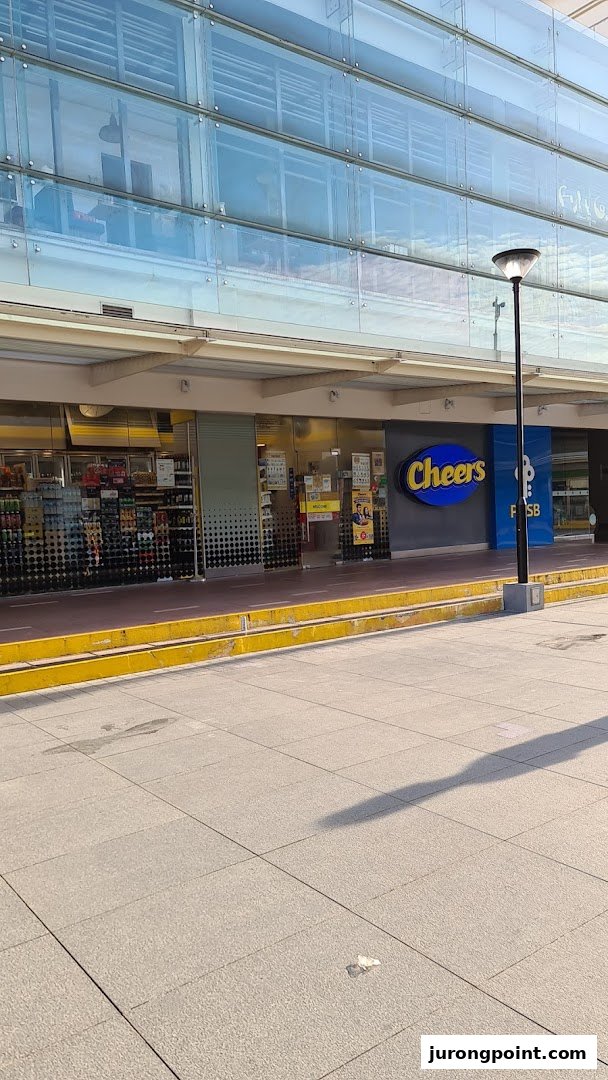 The storefront of a Cheers convenience store with its distinctive blue and yellow logo.