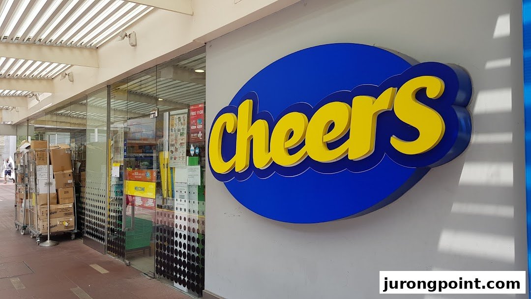 The exterior of a Cheers convenience store featuring its prominent blue and yellow logo and glass entrance.