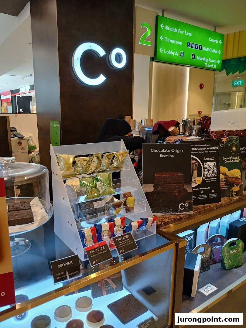 A Chocolate Origin counter displaying delicious brownies, financiers, and other sweet treats.