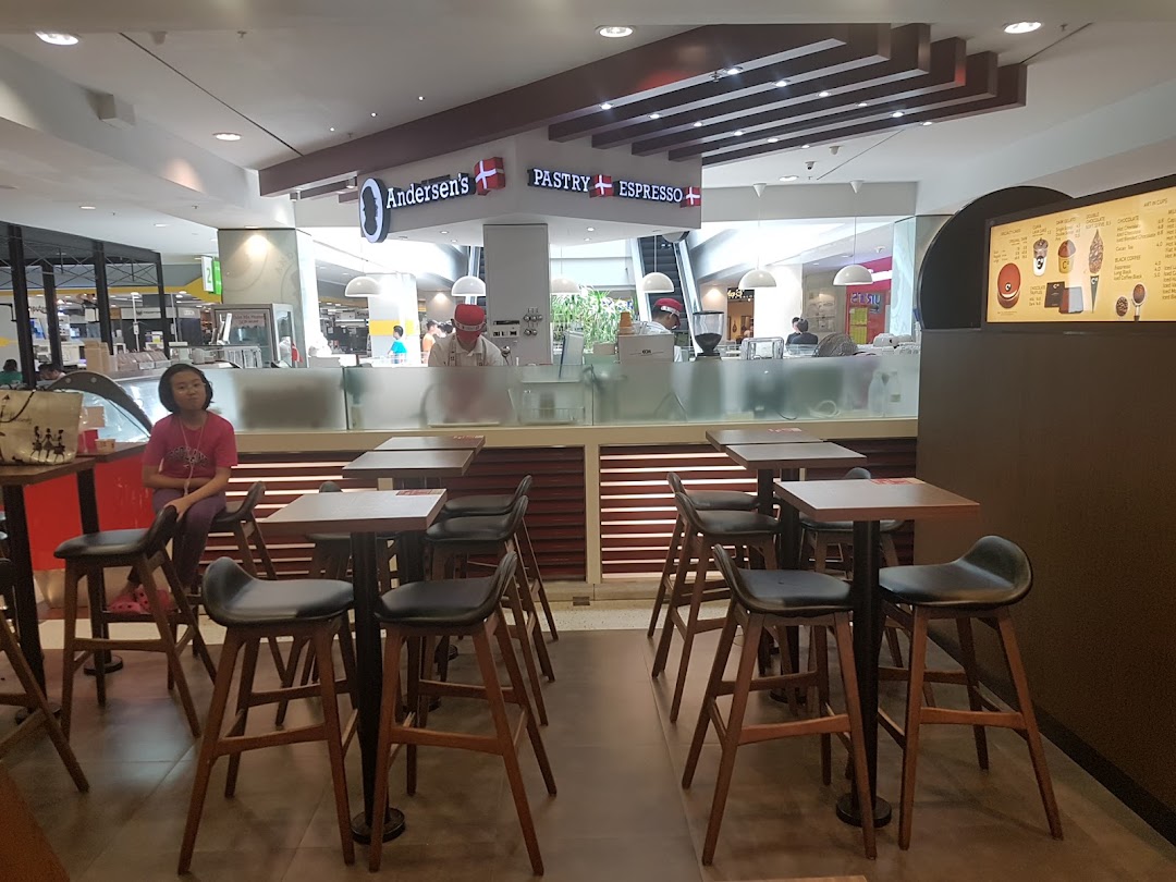 Interior view of Andersen's cafe featuring a prominent menu board, counter, and seating area.