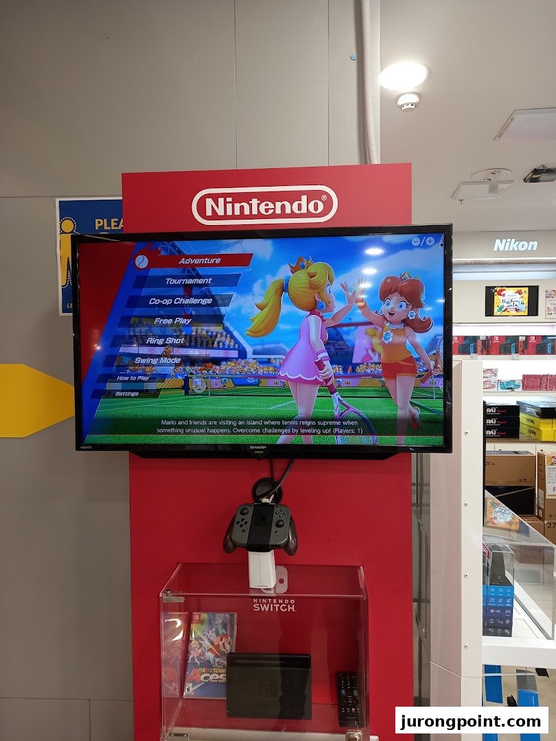 A Nintendo Switch demo station with a game playing on screen and a controller available for trial.