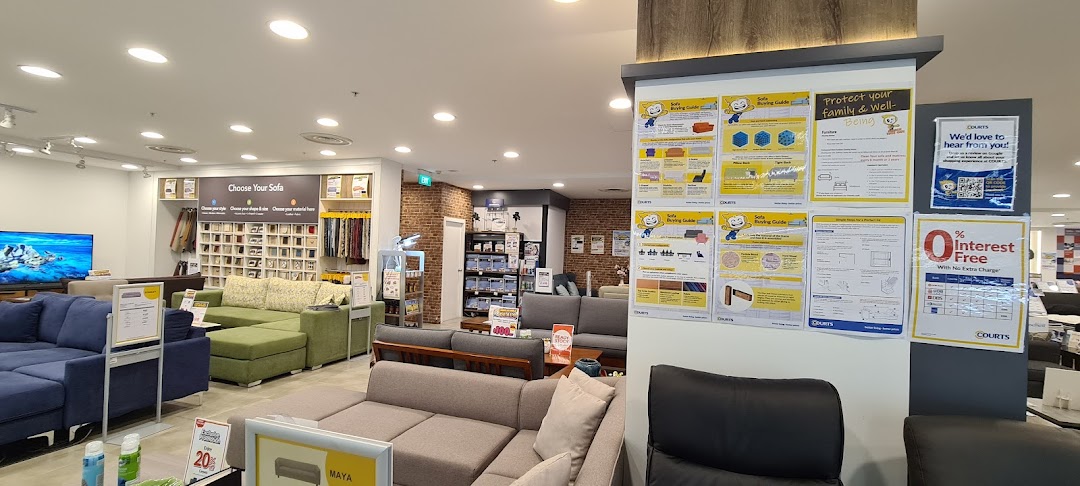 Interior view of COURTS furniture store displaying a wide selection of sofas and home furnishings.
