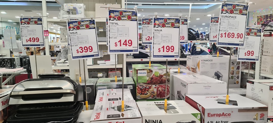 An interior shot of COURTS showcasing various home appliances and electronics with promotional price tags.