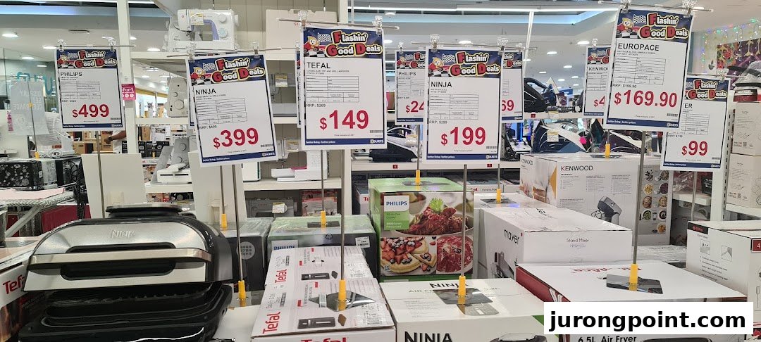An interior shot of COURTS showcasing various home appliances and electronics with promotional price tags.
