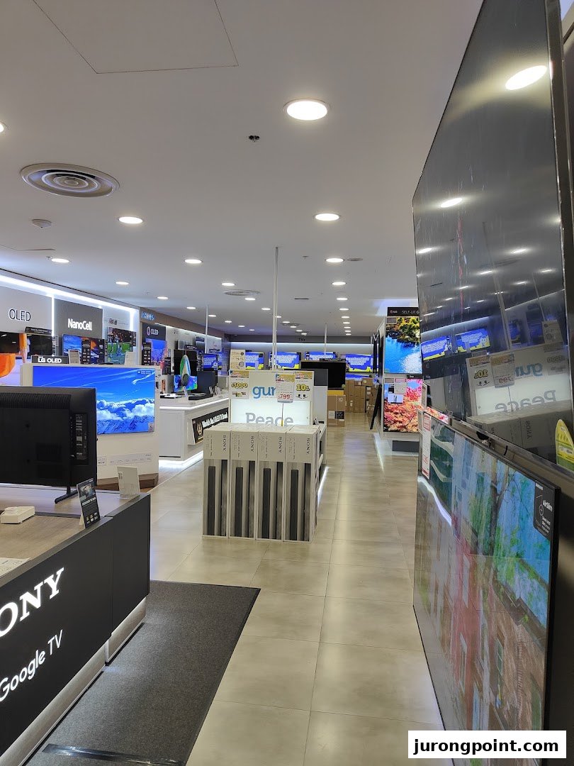 An interior view of COURTS electronics store, showcasing a wide array of televisions and home entertainment systems.