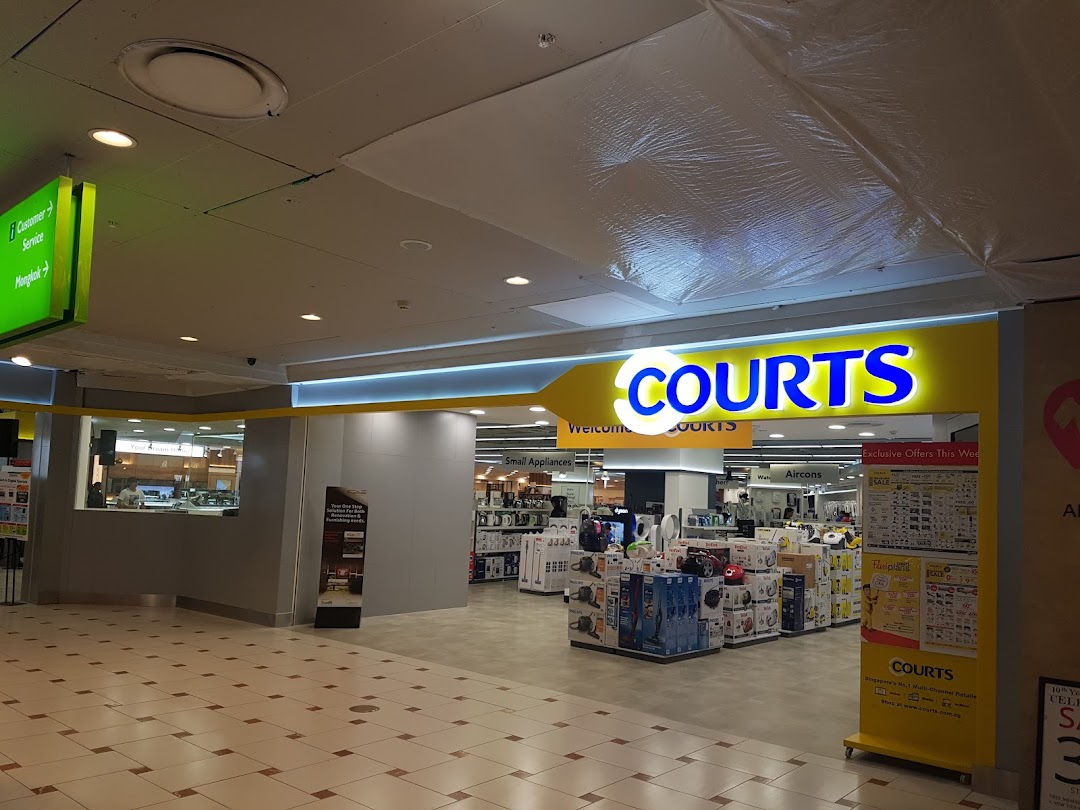 The bright entrance of COURTS, an electronics and home appliances store, showcasing its wide product range.