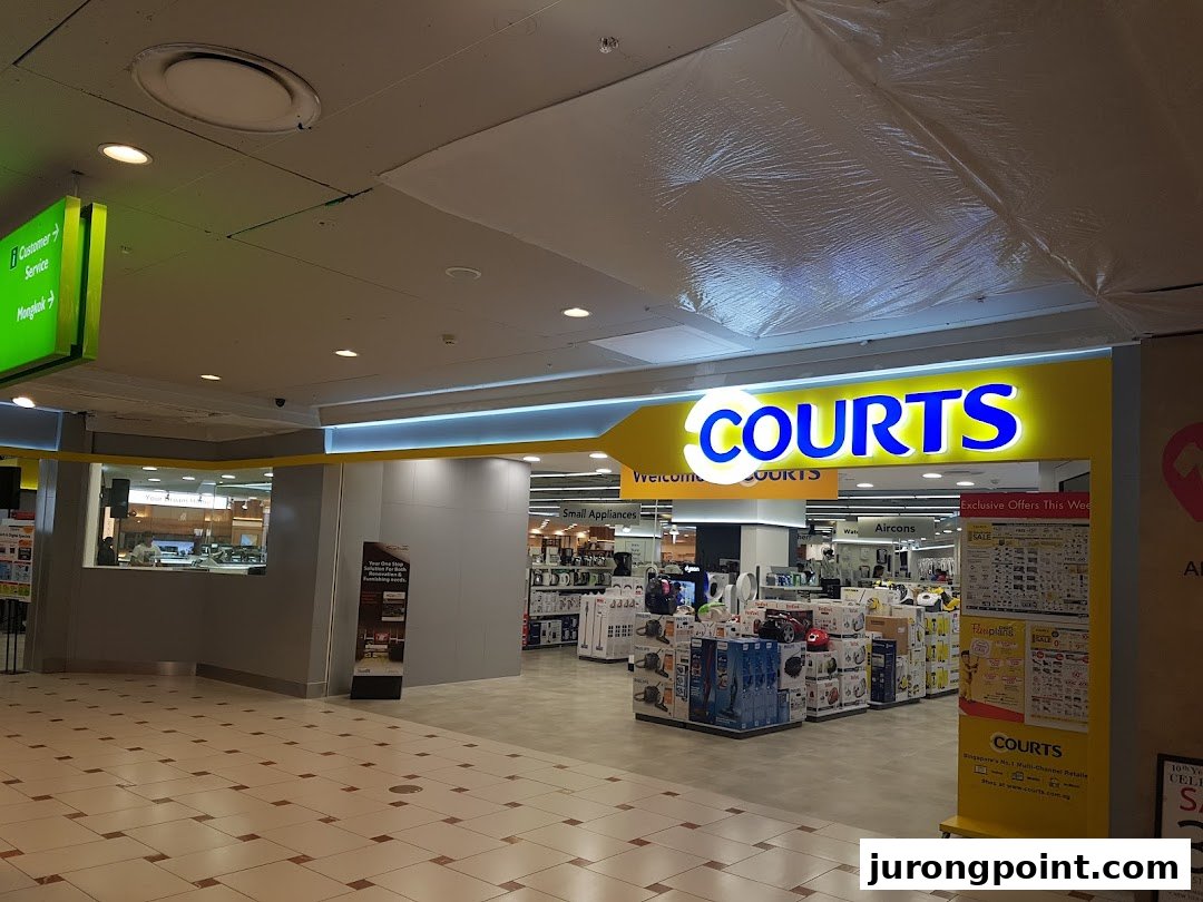 The bright entrance of COURTS, an electronics and home appliances store, showcasing its wide product range.