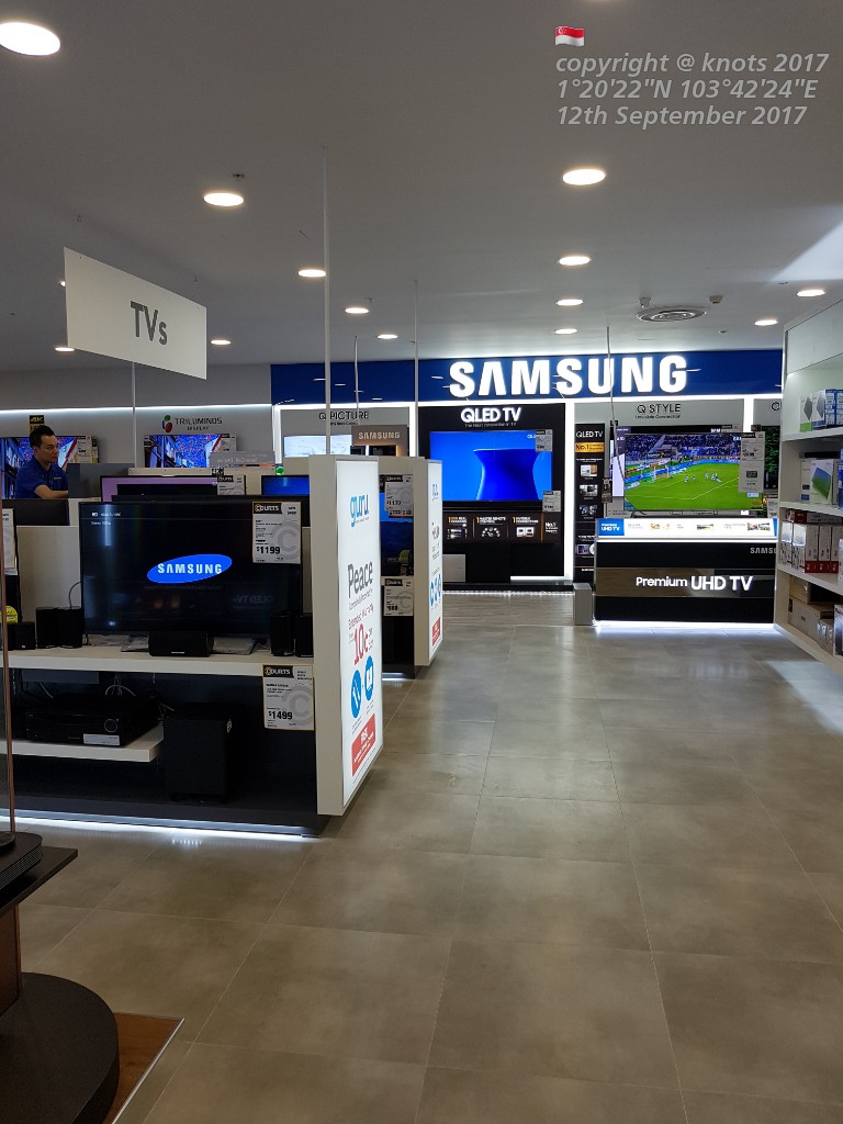 Interior view of COURTS electronics store, showcasing a wide range of Samsung TVs and home entertainment systems.
