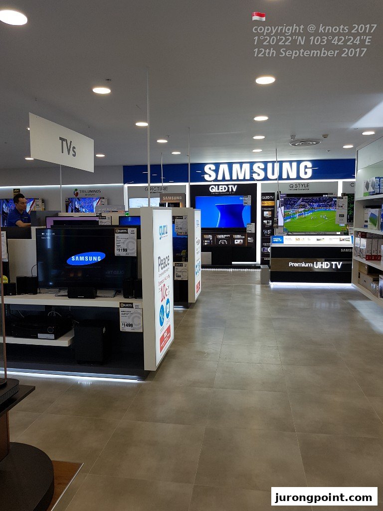 Interior view of COURTS electronics store, showcasing a wide range of Samsung TVs and home entertainment systems.
